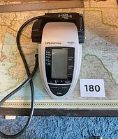 CVS Pharmacy digital blood pressure monitor with arm cuff displayed on table