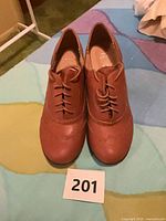 Top view of both brown lace-up shoes showing style and color