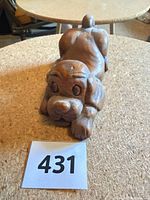 Front angled view of carved wooden dog figurine