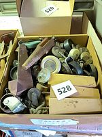 Box filled with various casters, glide discs and hardware