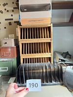 Overall view showing wooden CD rack, metal letter trays, plastic CD holder, metal file boxes