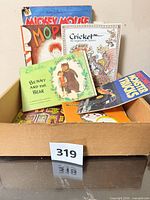 Box of children’s books showing Mickey Mouse, Mop, Cricket, Benny and the Bear, Monster Trucks