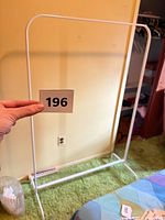 Front view of white metal clothing rack