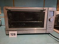 Front view of stainless steel Cuisinart toaster oven showing glass door and control panel