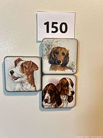 All three dog-themed ceramic magnets on refrigerator door, crack visible on Jack Russell magnet