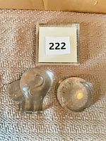 Three clear glass paperweights arranged on surface