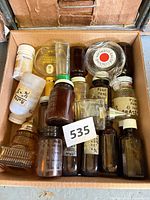 box containing assorted glass bottles and jars