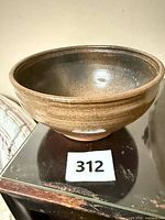 Side view of handmade glazed clay bowl