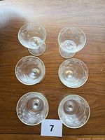 Top view showing six matching etched cocktail glasses
