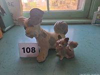 Front view of both porcelain dog figurines