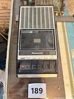 Front view of Panasonic RQ-2103 cassette recorder showing speaker grille, cassette window and control buttons