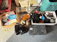 Overview of all boxes and bins of photo accessories on floor