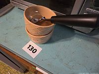 Stacked ceramic bowls with scoop resting on top