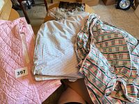 Lot overview showing three tablecloths stacked