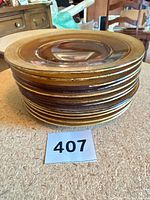 Stack of 12 amber glass plates