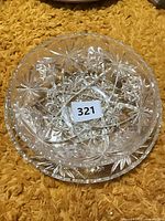 Overhead view of round pressed glass Star of David bowl resting on matching platter