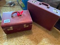Both burgundy cases side by side on carpet