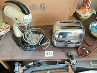 Sunbeam Mixmaster mixer with beaters beside chrome toaster