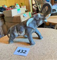 Side view of grey ceramic elephant planter with trunk raised