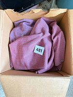 Box with dusty-rose geometric print fabric and lot tag