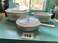 Front view showing all three Corning Ware pieces with lids