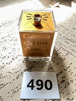 Front view showing Canon logos through clear acrylic body