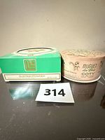 Indiscret box and Coty container side by side