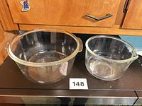 Two clear glass Fire-King bowls side by side
