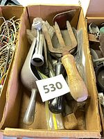 Box of assorted vintage garden hand tools with label 530 visible