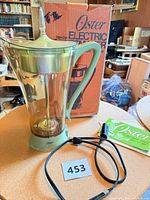 Coffeemaker assembled with box, booklet and power cord visible