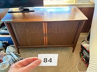 Front view showing Magnavox cabinet with tambour doors