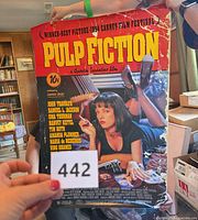 Front view of full Pulp Fiction poster held upright