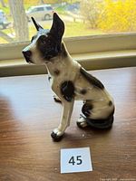 Front-left view of the seated black and white Great Dane ceramic figurine