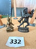 Both figurines front view on table with lot number