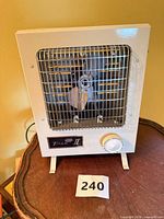 Front view showing grille, badge, control knob and feet