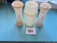 Front view of the three Tupperware pieces: two tall shakers and one mixer