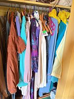 Closet rail showing majority of garments, variety of colours and styles