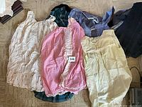 Group of dresses and tops laid out