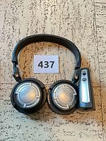 Headphones and transmitter laid flat on floor