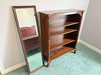 Bookcase front and leaning mirror full view