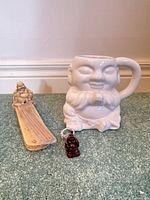 Group shot of Buddha mug, incense holder, sticks, keychain