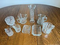 All nine pressed glass pieces grouped on table