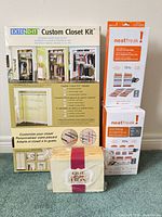 Group shot of boxed closet kit, two vacuum bag boxes, wrapped purse box