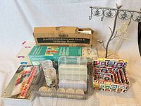 Full lot overview showing boxed jewelry organizer, ribbon organizer, metal jewelry stand, basket with cases and jars, nesting boxes