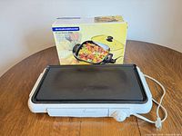 Toastmaster electric griddle in front of Durabrand skillet box