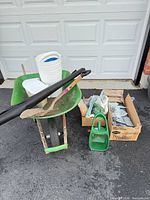 Overall lot with wheelbarrow, shovel, buckets, edging, boxes, watering can