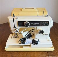 Front view of Kenmore sewing machine with foot pedal and case
