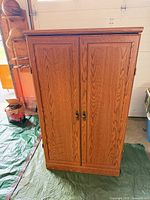 Front view of closed oak armoire