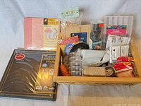 Overall lot in basket showing album, scrapbook kit, tools, twine, beads, storage