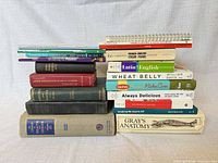 Two stacks of approximately twenty assorted medical, cookery, language and reference books